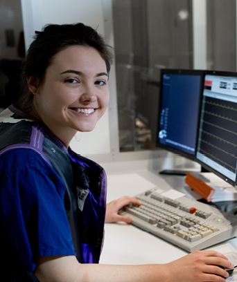 Female physiologist sitting in front of computer