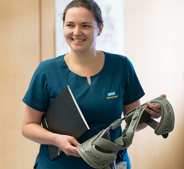 Female orthotist holding equipment