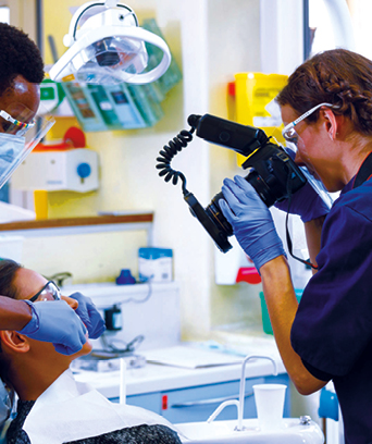 Female taking clinical photos of patient