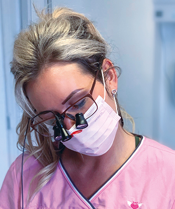 Female dentist treating patient