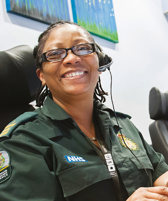 Female in uniform sitting in ambulance control room