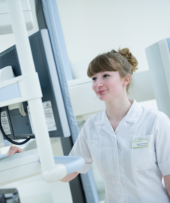 Female diagnostic radiographer at x-ray machine