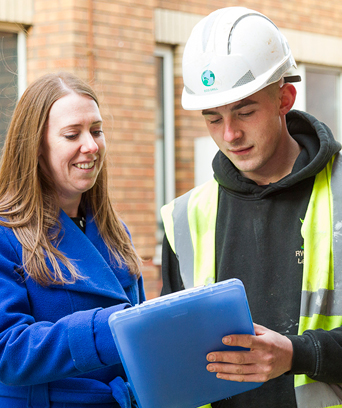 Female manager talking to man in high vis vest