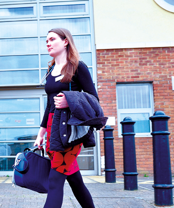 Female walking away from building