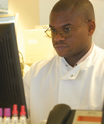 Male scientist studying computer screen