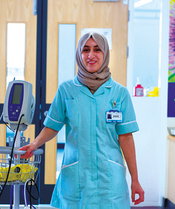 Female in headscarf walking down corridor