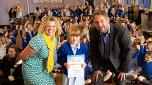 Female pupil and teachers at class assembly