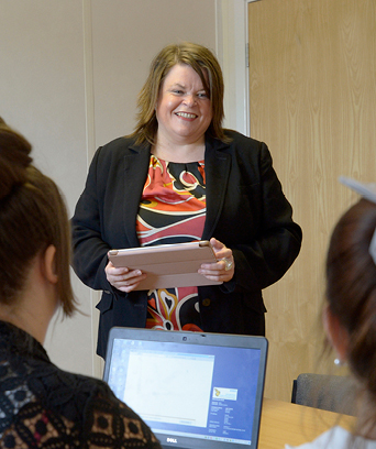 Female standing in front of group presenting