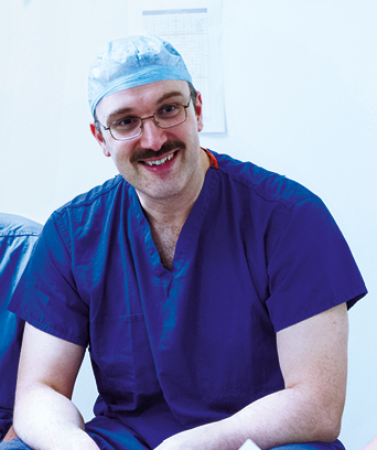 Male technologist in scrubs