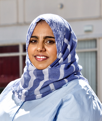 Female nurse in headscarf looking at camera