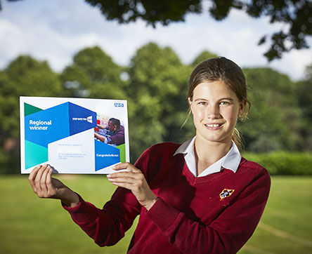 Student holding certificate