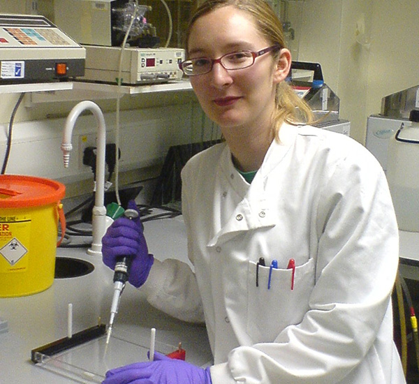 Female scientist in lab coat with equipment