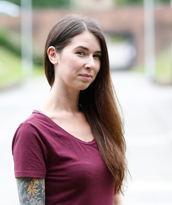 Female standing outside looking at camera