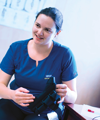 Female orthotist holding equipment