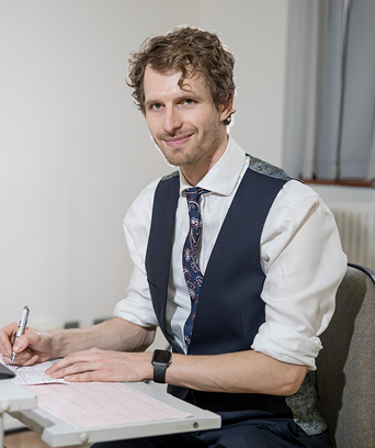 Male psychologist writing at desk