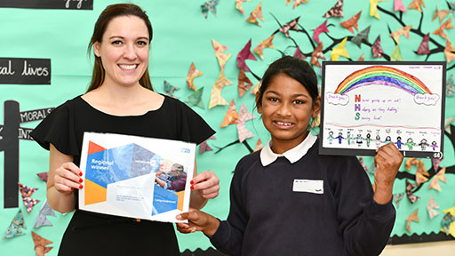 Female pupil and teachers at class assembly