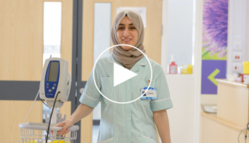 Female in headscarf walking down corridor